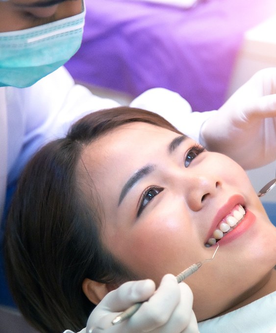 A girl showing her dentist a new tooth
